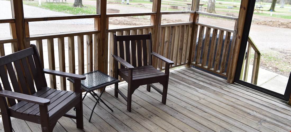 Outside seating and deck of the bunk beds with loft deluxe cabin